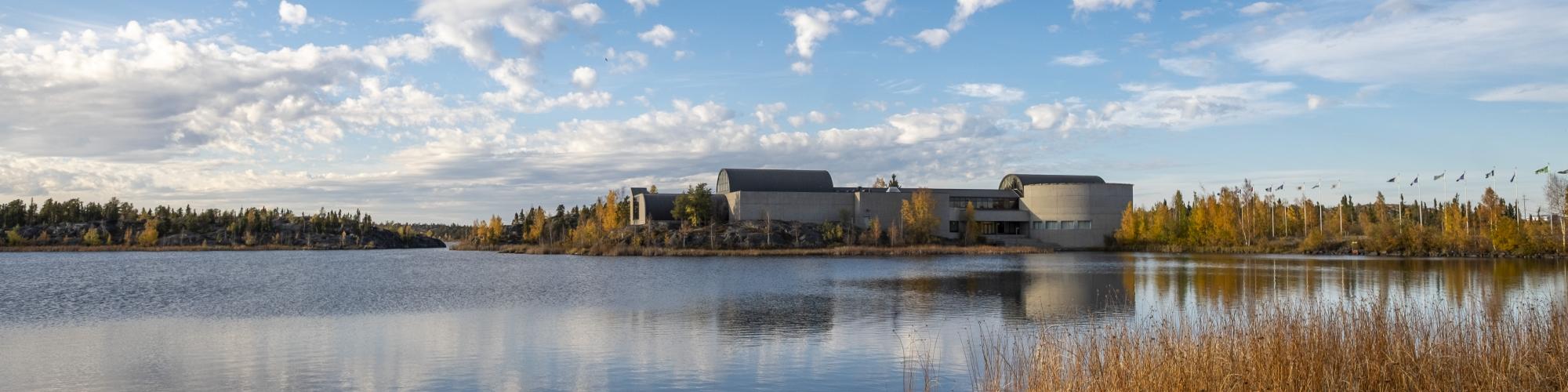 Image of the museum in fall from across Frame Lake