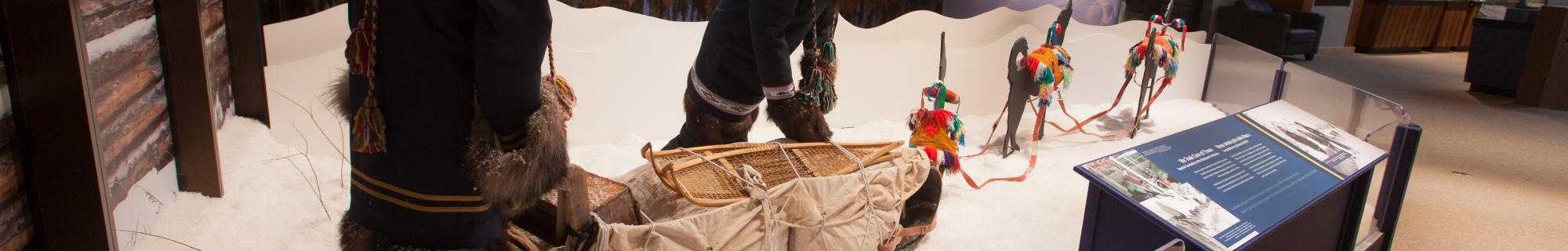 Image of display of two people with a snow dog team