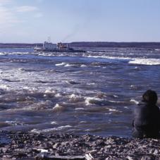 September 28, 1969. Upstream from Fort Good Hope (Radeyilikoe), a Northern Transportation Company ship inches it's way up the Mackenzie River (Dehcho).