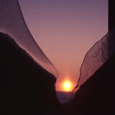 The sun rises in Fort Resolution (Denínu Kųę), January 1970.