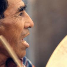 Menton Mantla celebrating with a traditional drum, July of 1979.