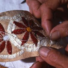 Porcupine quill artwork created by Ms. Sarah Hardisty of Jean Marie River (Tthek'hedeli), August 1976. The quills are washed with hot water and detergent. They are then dyed with direct dyes. There are several traditional techniques of porcupine quill embroidery.